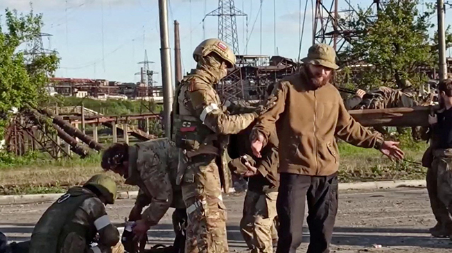 service members of ukrainian forces who left the besieged azovstal steel plant are searched by the pro russian military in mariupol