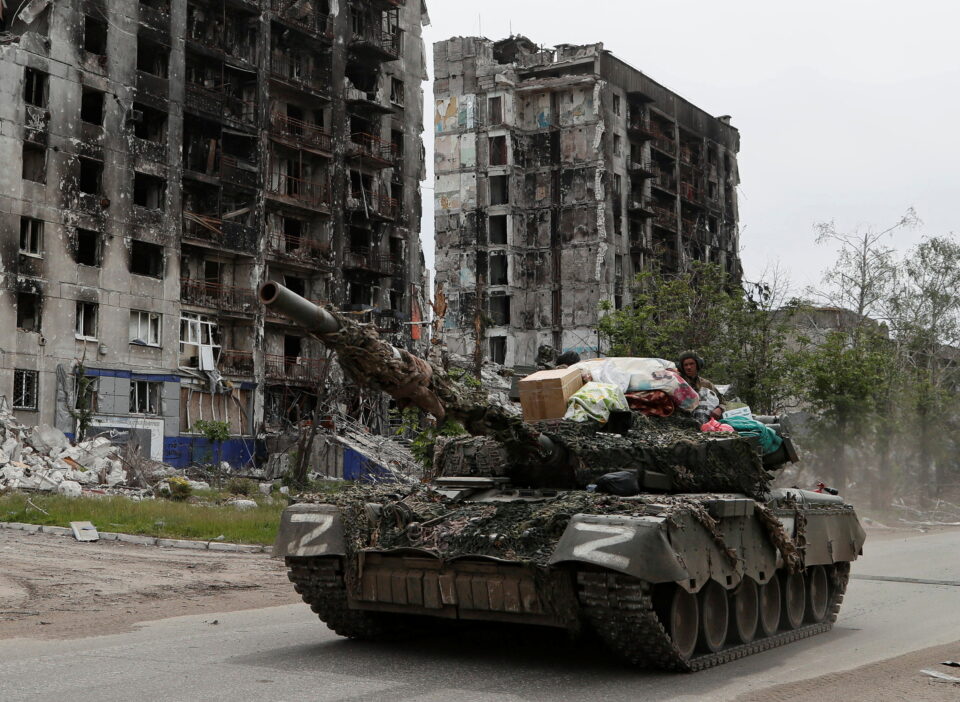 service members of pro russian troops drive a tank along a street in popasna