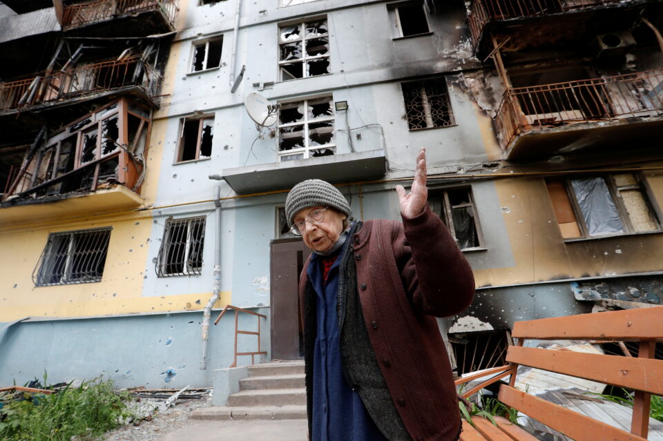 a local resident speaks in a courtyard in mariupol