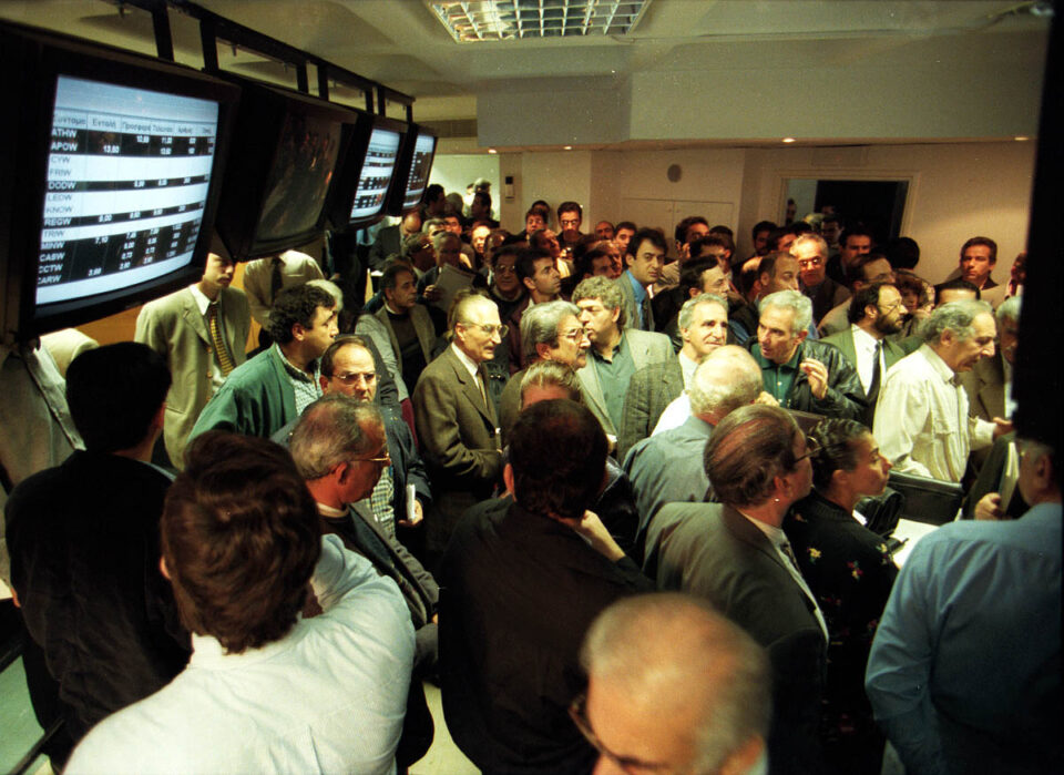 feature kyriacos main investors anxiously checking the markets at the height of the stock exchange bubble in 1999