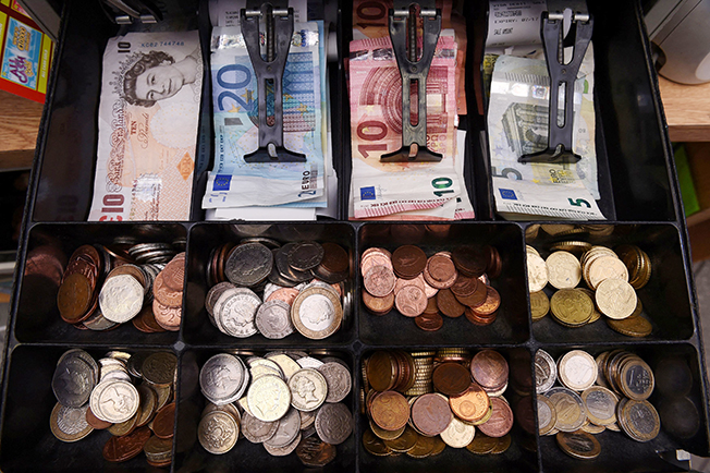file photo: a shop cash register is seen with both sterling and euro currency in the till at the border town of pettigo