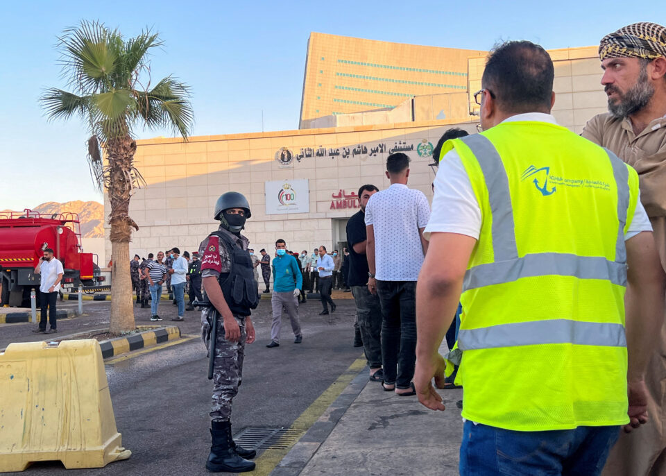people stand outside a hospital after toxic gas leak from a storage tank in jordan's aqaba port