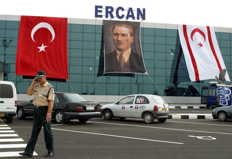 a security guard stands in front of the ercan airport