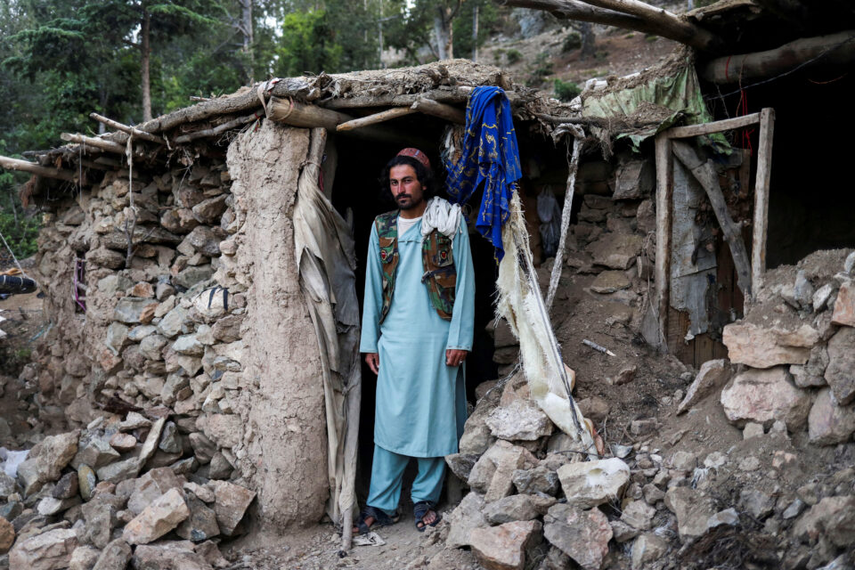barakatullah poses for a picture in front of his house that was damaged by an earthquake in spolgin village, spera district of khost province