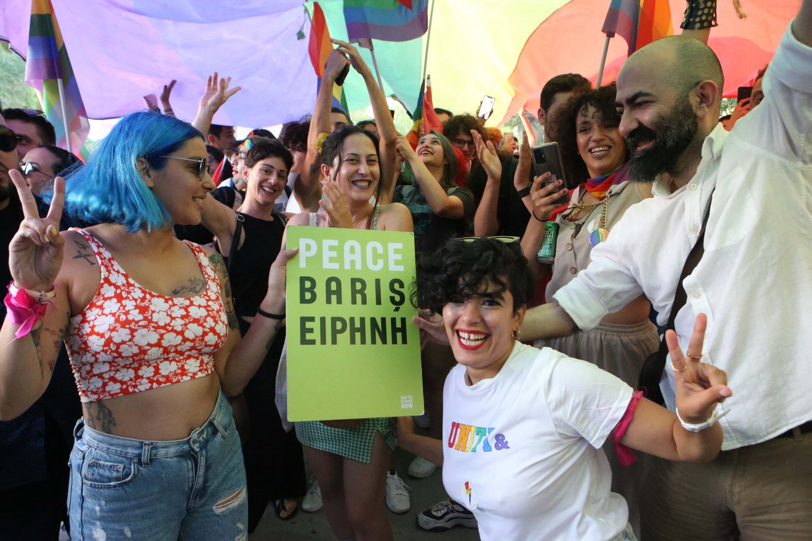 image Two parts of rainbow flag sewn together at first intercommunal pride parade (with video)