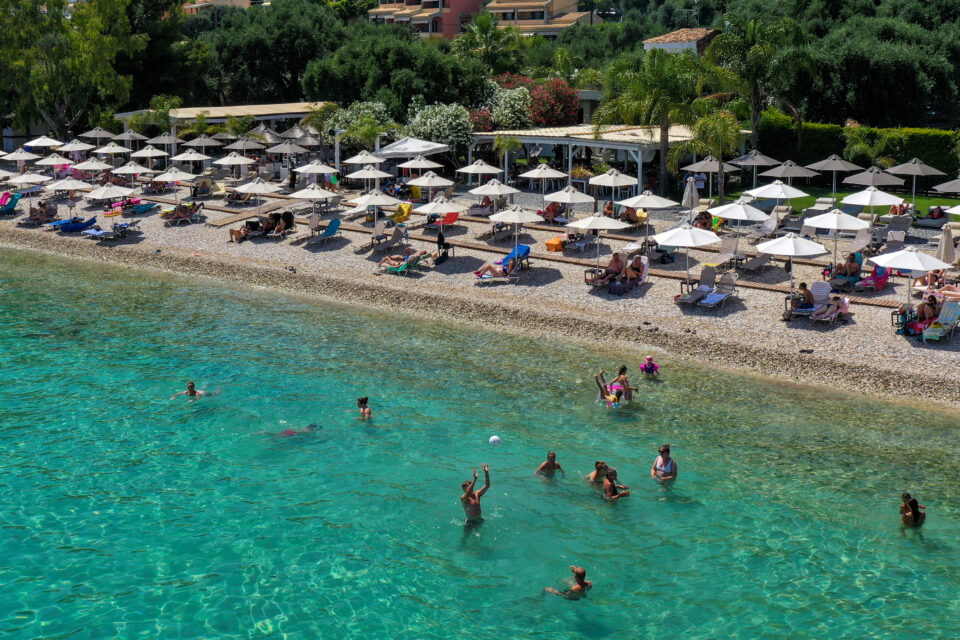 people enjoy the sea at barbati beach on the island of corfu