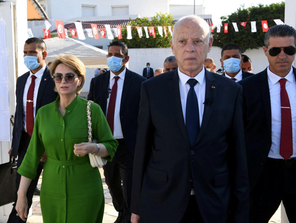 tunisia's president kais saied and his wife ichraf chebil walk outside a polling station, during a referendum on a new constitution in tunis