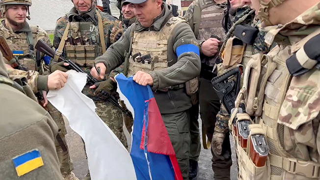 vyacheslav zadorenko rips a russian flag in kozacha lopan