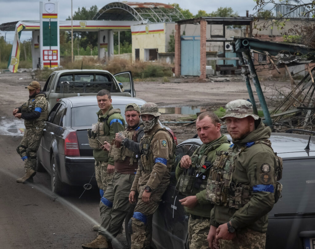 ukrainian servicemen rest on the road as they head to a front line in kharkiv region