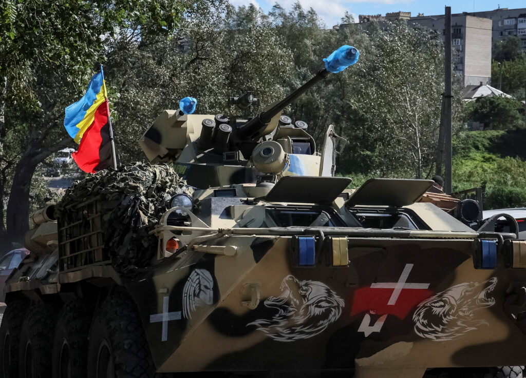 ukrainian armoured personnel carrier (apc) drives near the town of izium