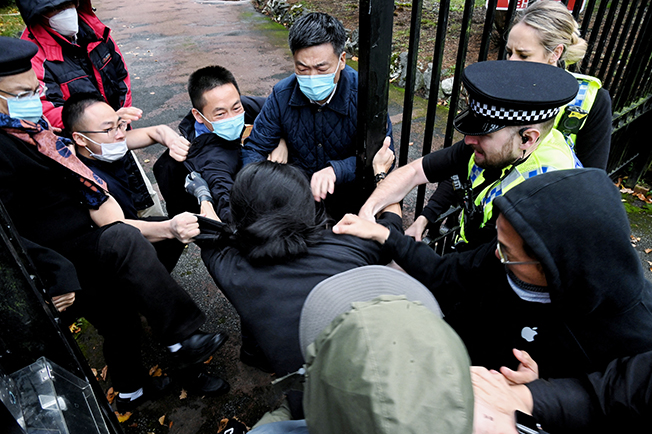 image British police probe beating of protester on China consulate grounds