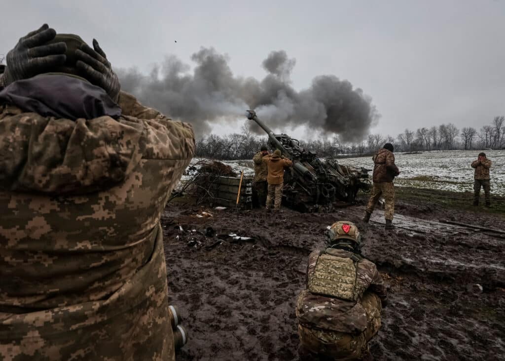 ukrainian service members fire a shell from an m777 howitzer at a front line in donetsk region