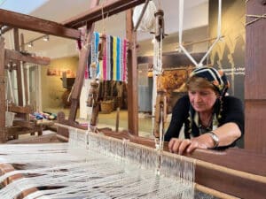 domestic tourism a woman works on a traditional loom
