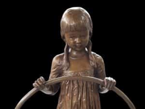 bronze statue girl with the hula hoop