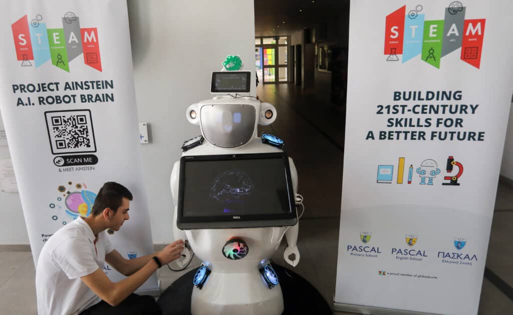 high school student konstantinos timinis works on "alnstein", a robot powered with chatgpt, in pascal school in nicosia