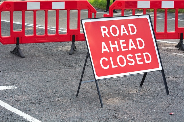 JFK street closed due to debris from winds, crews onsite