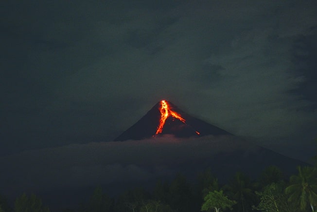 cover 14,000 people evacuated as Philippine volcano spews lava