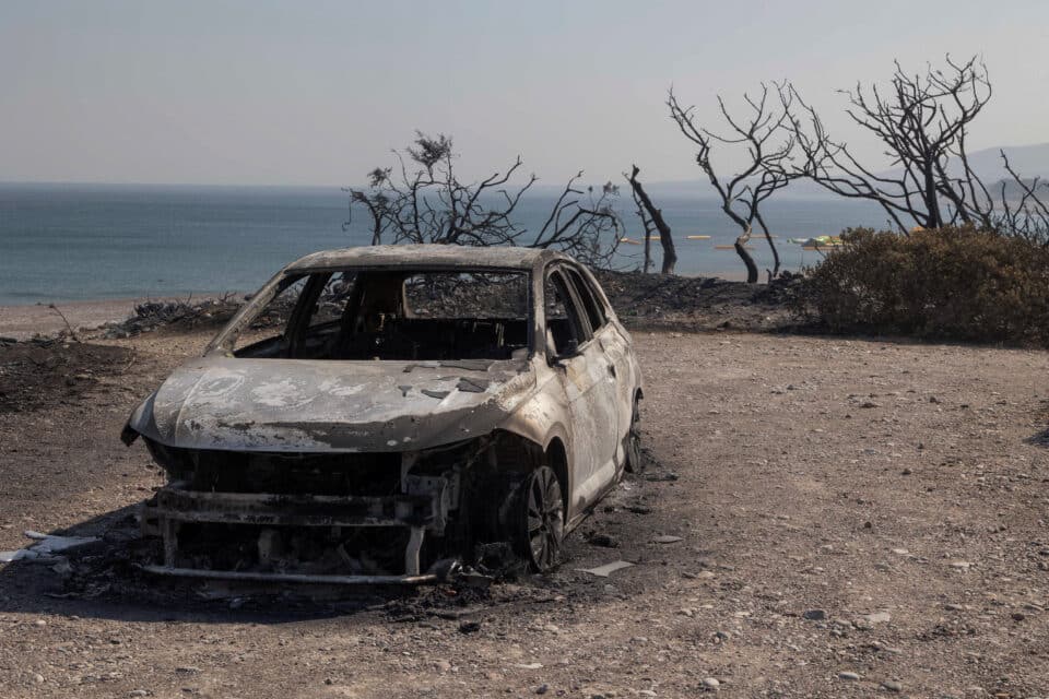 A burned car is seen on a beach in the village of Kiotari in Rhodes, Greece, July 24, 2023. REUTERS/Nicolas Economou