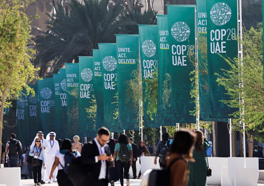 delegates walk at the united nations climate change conference cop28 in dubai