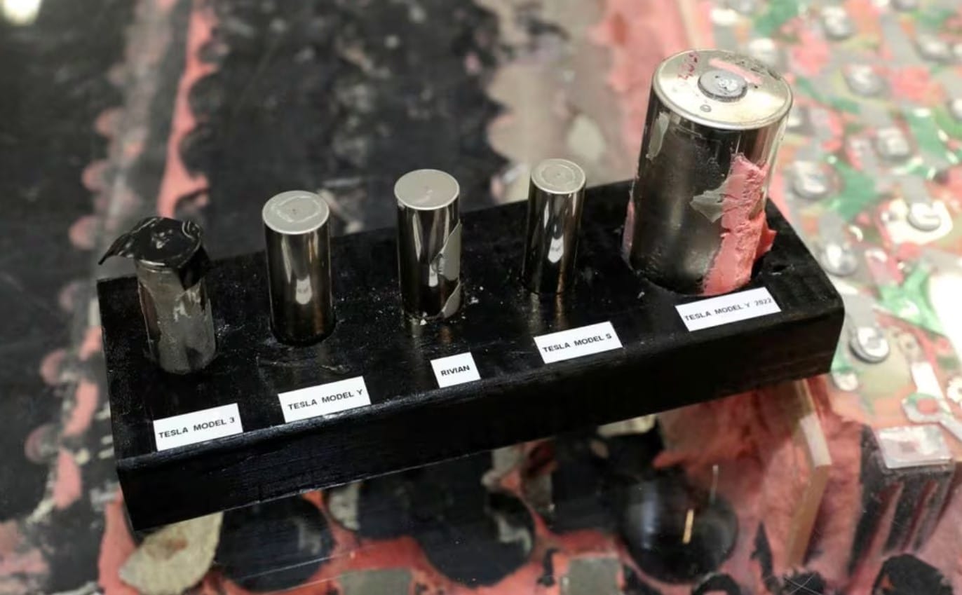 A Tesla 4680 cell from a structural battery pack pulled from a Tesla Model Y, built in Austin, Texas, is displayed next to a Tesla 18650 and 2170 battery cell in Auburn Hills, Michigan U.S. March 3, 2023. REUTERS/Rebecca Cook