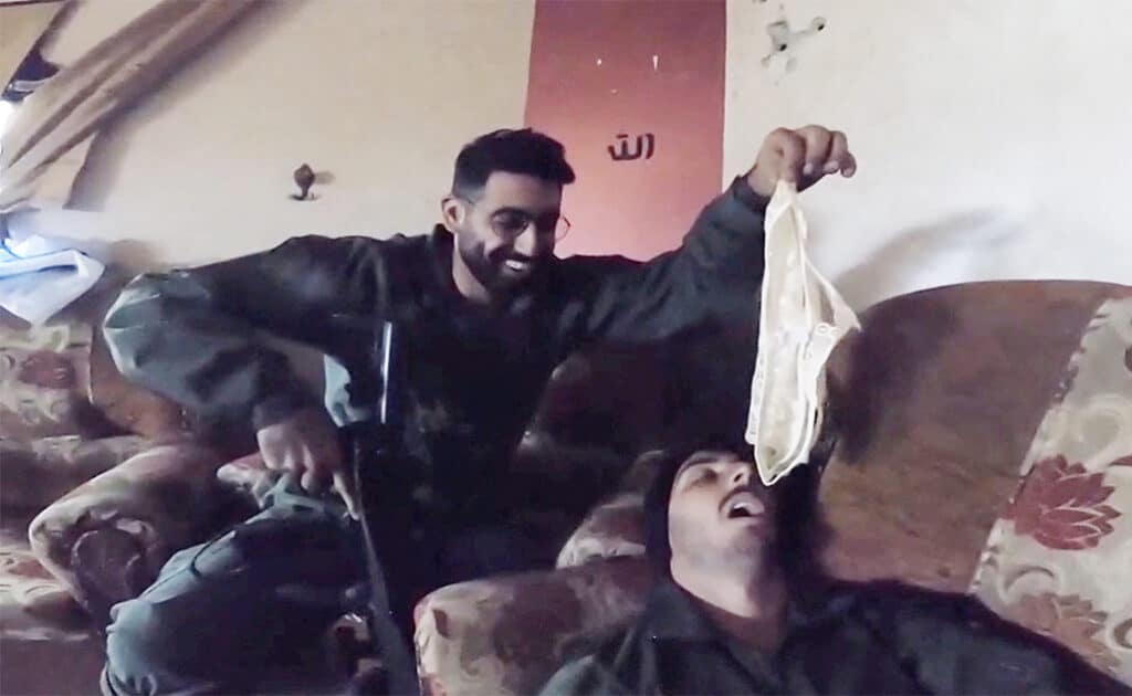 an israeli soldier holds underwear over the face of a fellow israeli soldier in a screengrab from a video