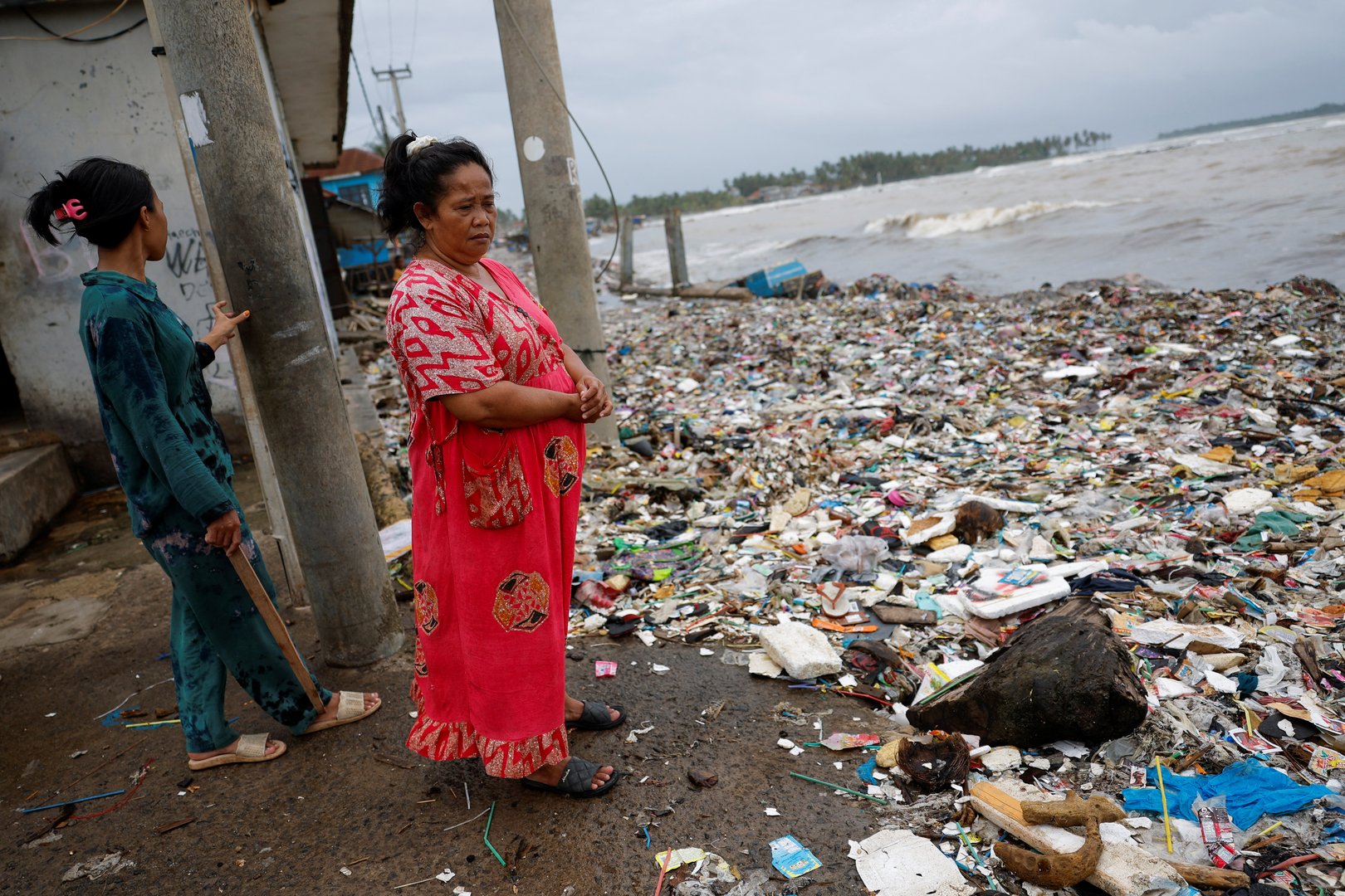 image Indonesia fishing village grapples with piles of trash brought in by tides