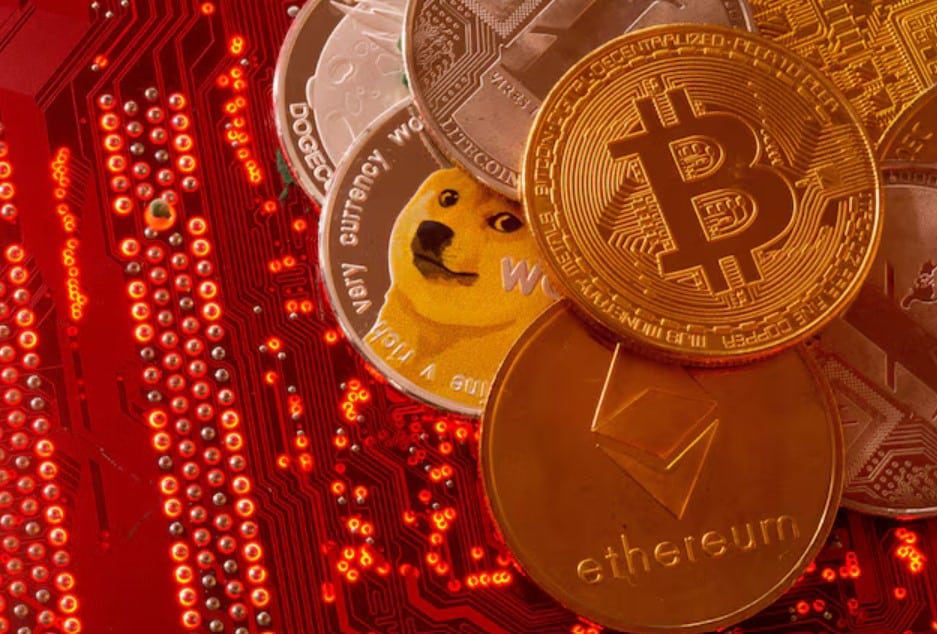 Representations of cryptocurrencies Bitcoin, Ethereum, DogeCoin, Ripple, Litecoin are placed on PC motherboard in this illustration taken, June 29, 2021. REUTERS/Dado Ruvic/File Photo