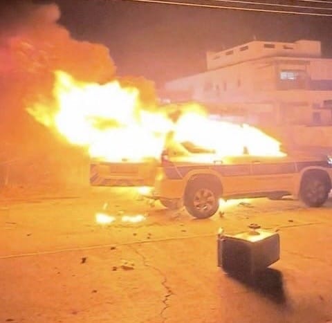 image Third man arrested over police car torching