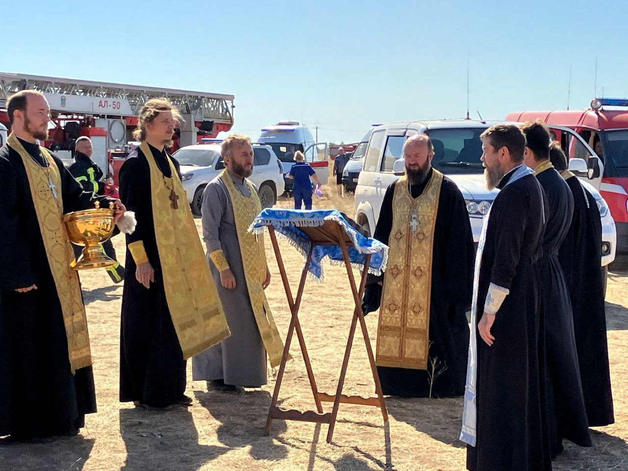 image Russian priests bring icon to try to tame depot fire after drone attack