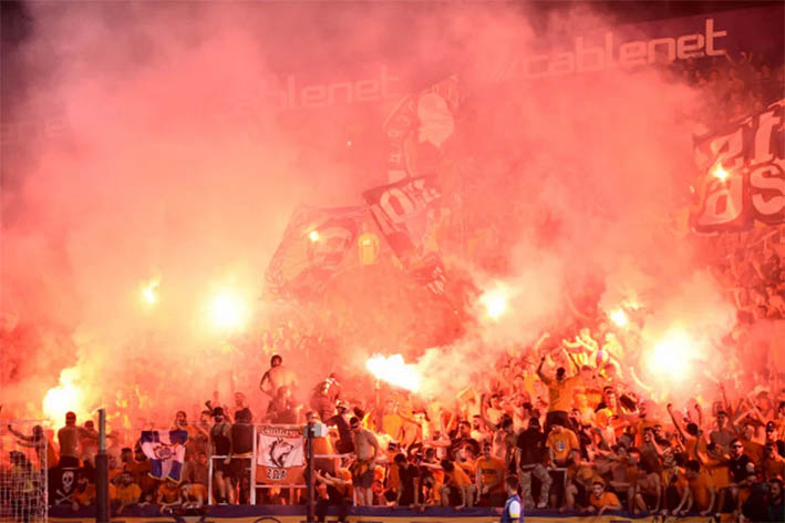 Man arrested for handing out smoke bombs at football match