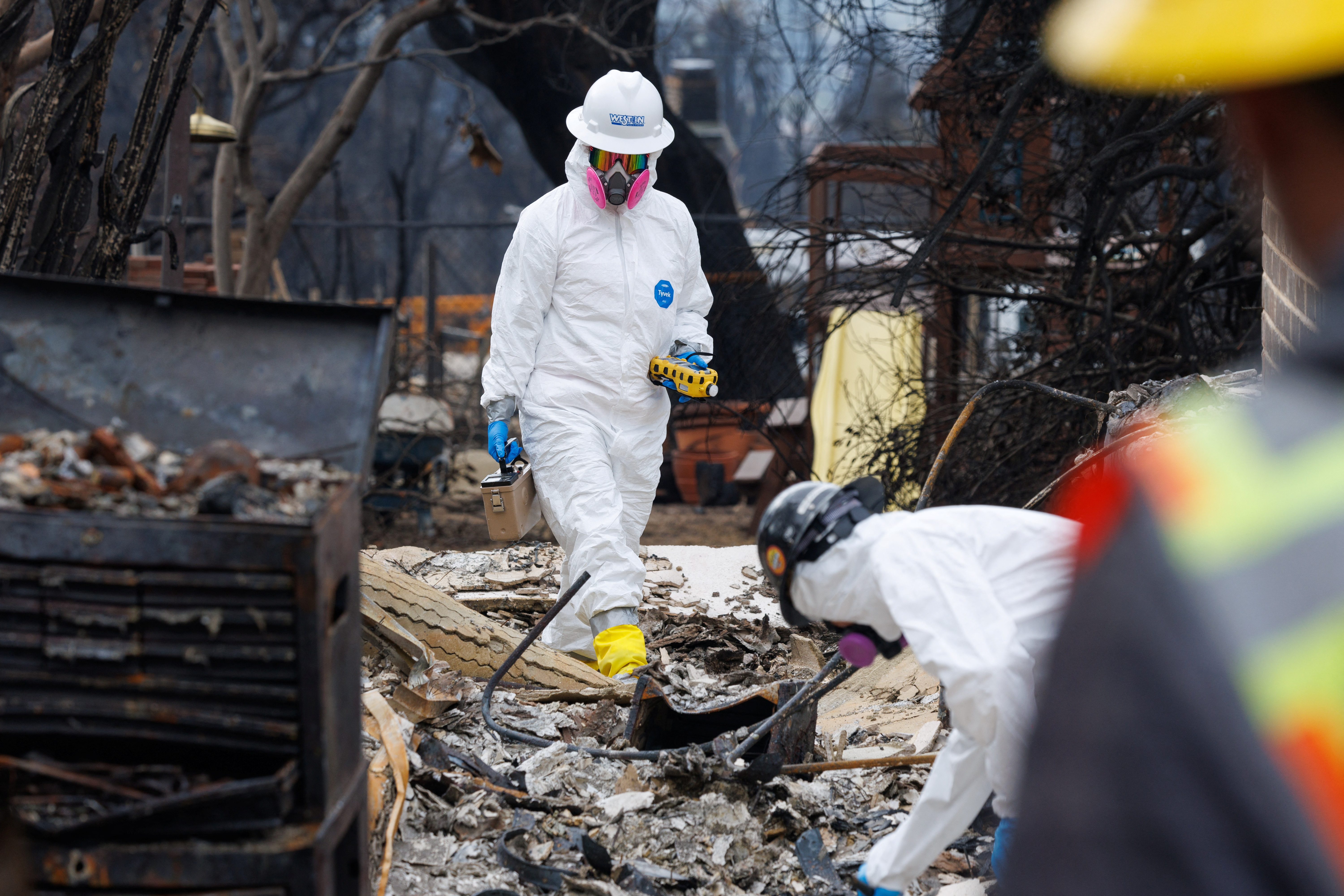 Environmental workers race to clear toxic debris left by LA fires