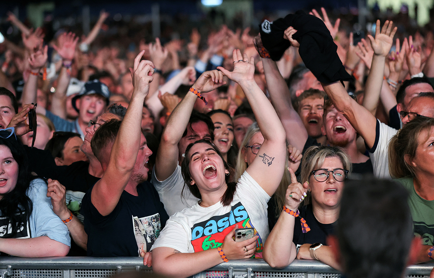 cover Hit-packed set as Oasis reunite, thrilling thousands