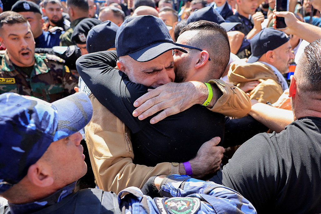 cover Palestinians cheer as freed prisoners begin to arrive home under ceasefire deal 