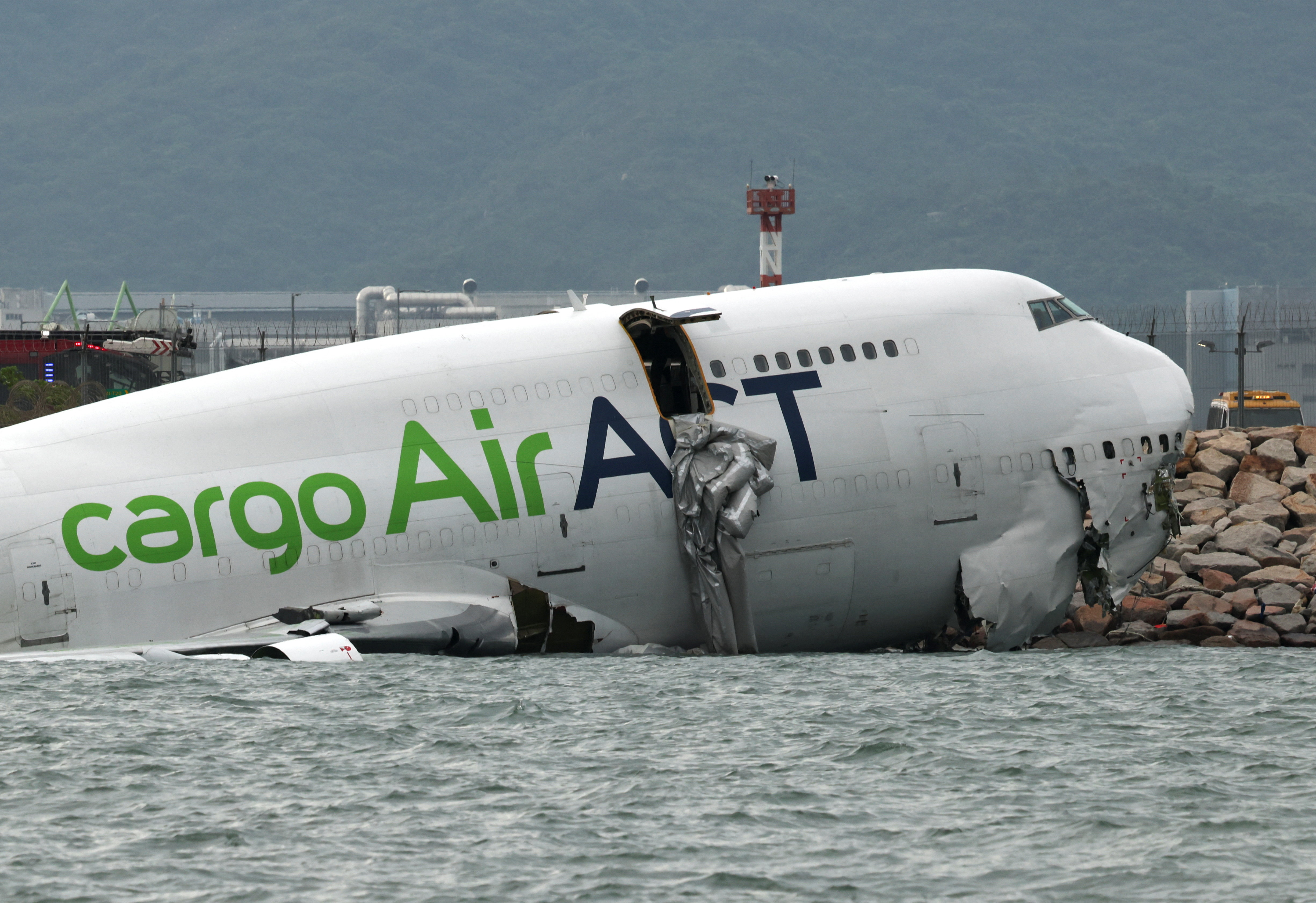 cover Cargo plane slides off runway in Hong Kong, killing two airport staff