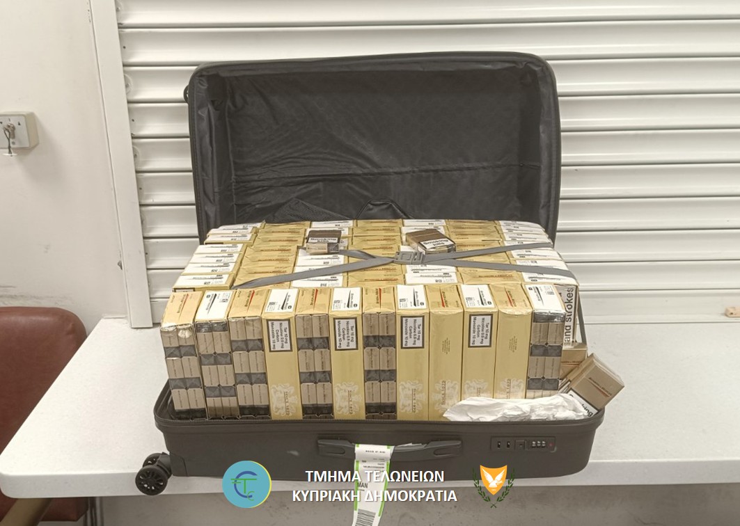 cover Sixty-five boxes of untaxed cigarettes found in suitcase
