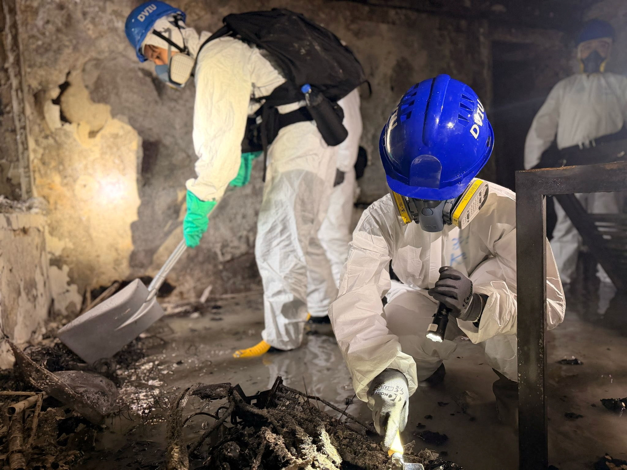 cover Hong Kong arrests 13 for apartment tower fire, blames use of renovation material