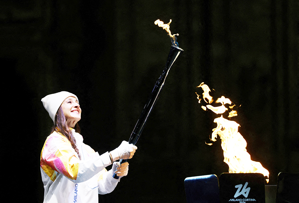 cover Olympic Torch arrives in Milan to cheers and protests