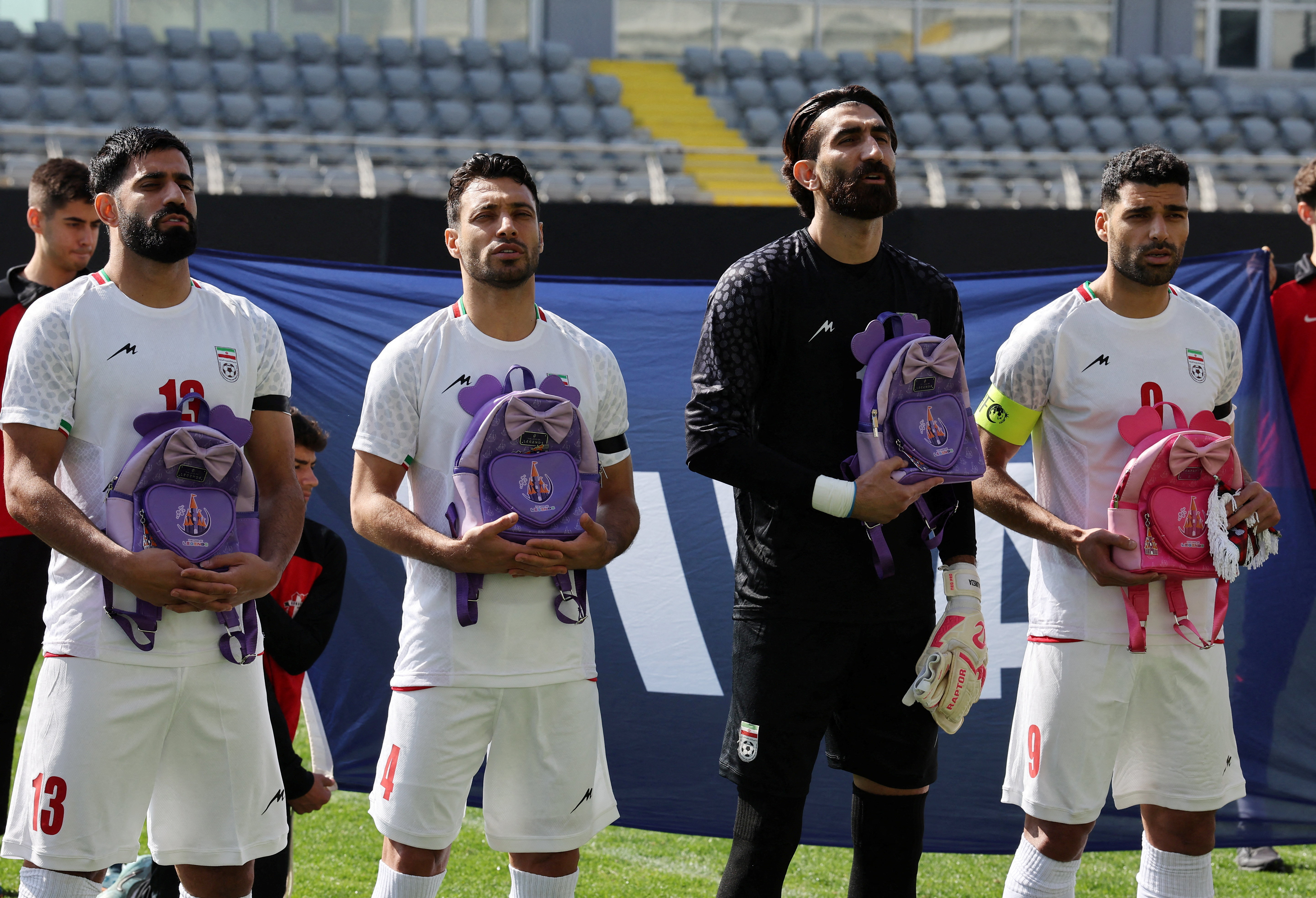 cover Iranian players hold schoolbags in solidarity with slain girls