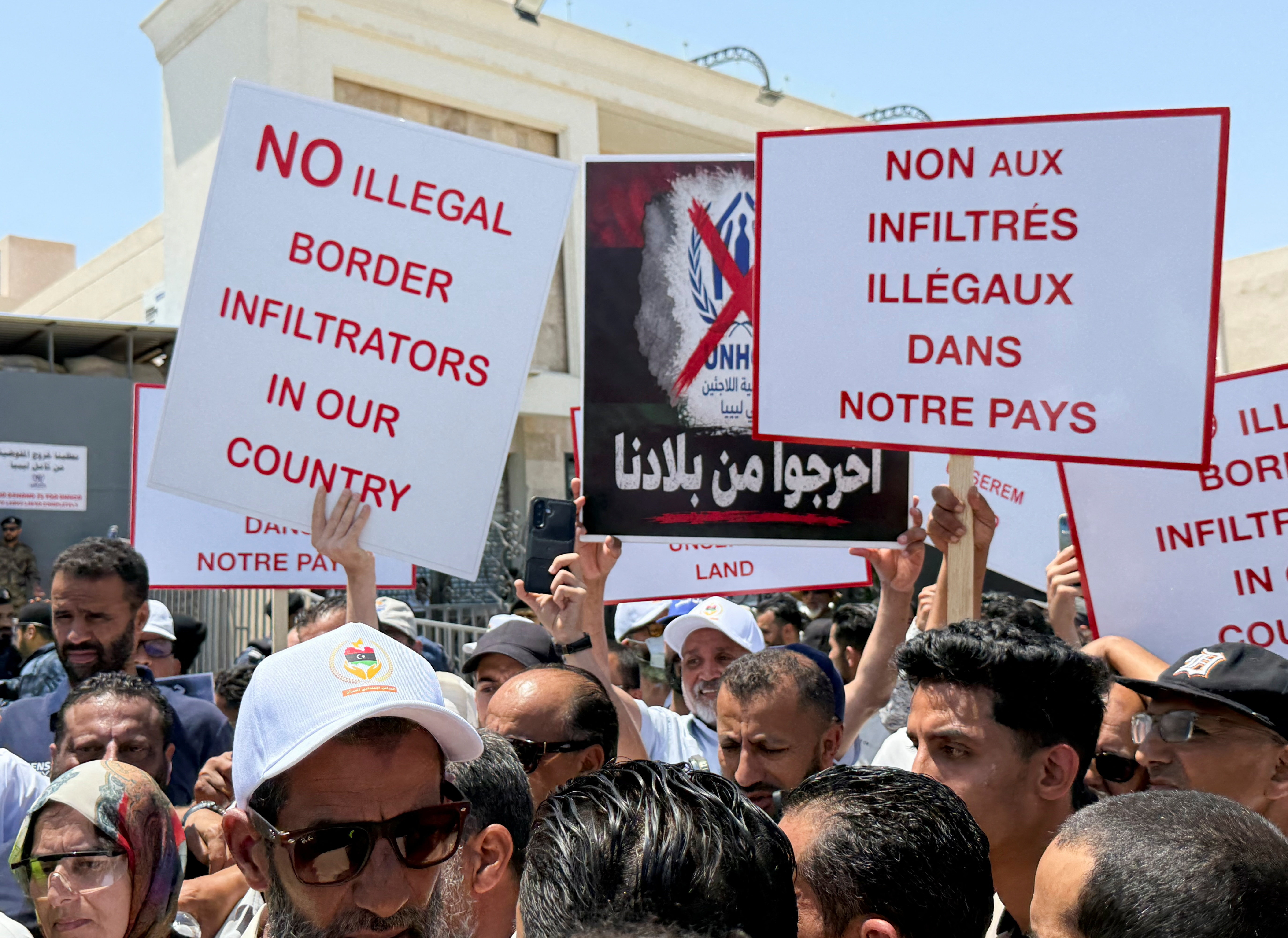 cover Libyans block off UN refugee office in protest against migrants