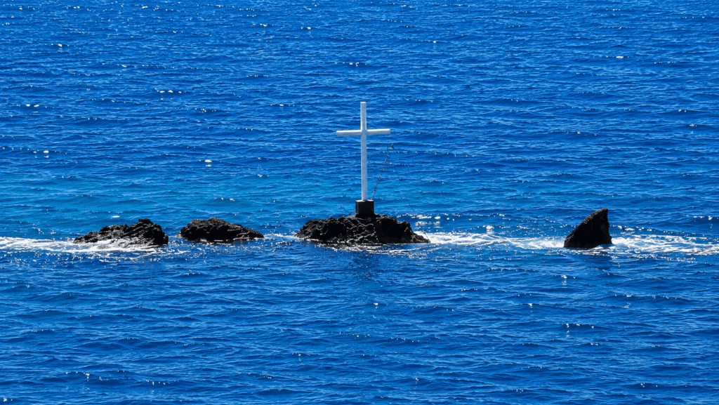 cover Father of merchant navy officer behind cross installation in Potima