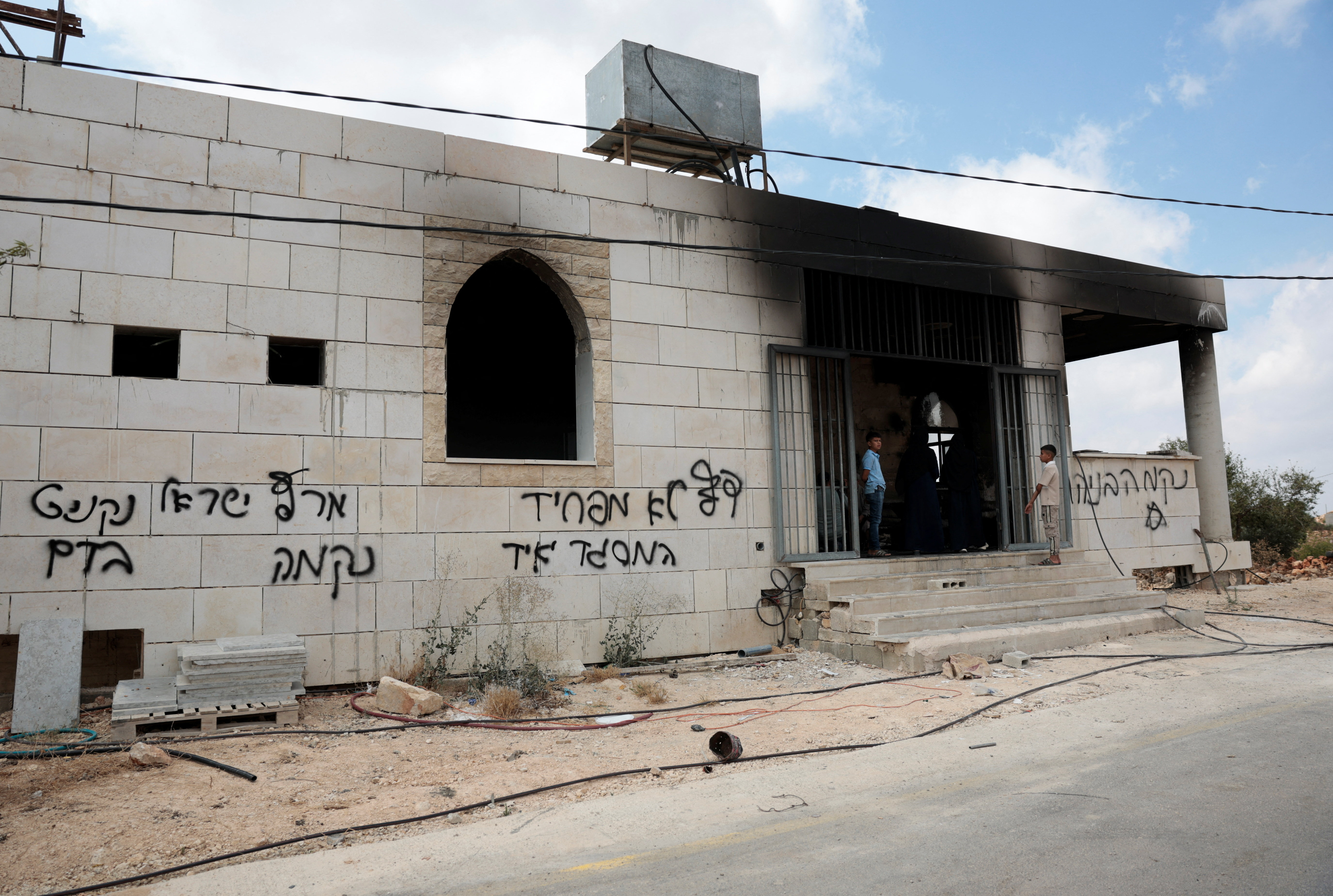 cover Israeli settlers set fire to West Bank mosques after deadly clash