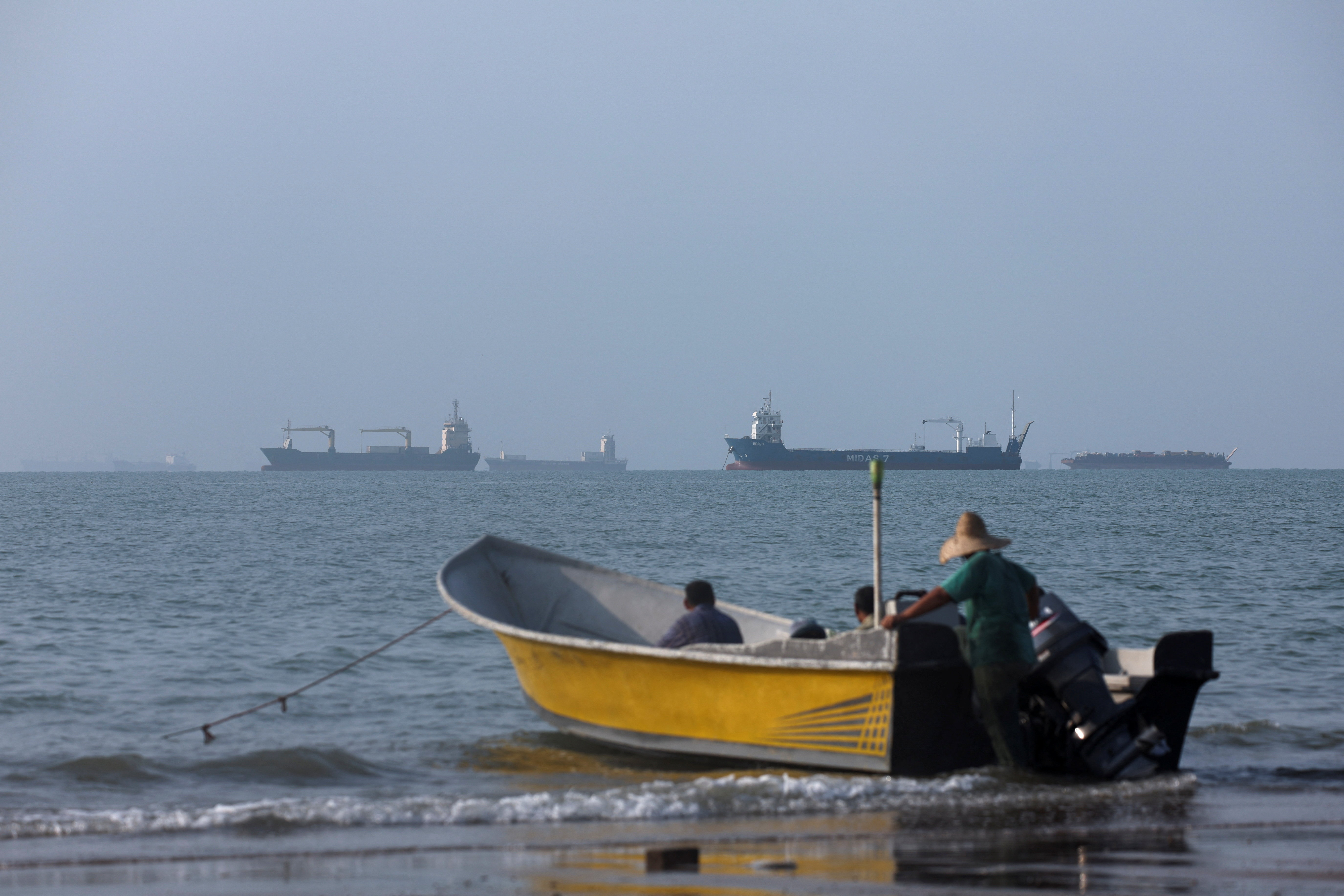 cover US, Iranian forces fire at vessels in waters near Iran