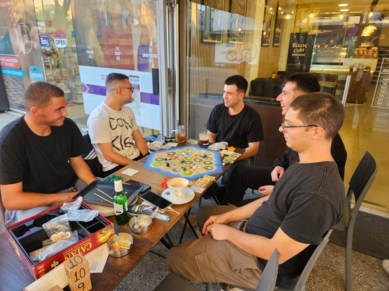 A group of youngsters playing Settlers of Catan