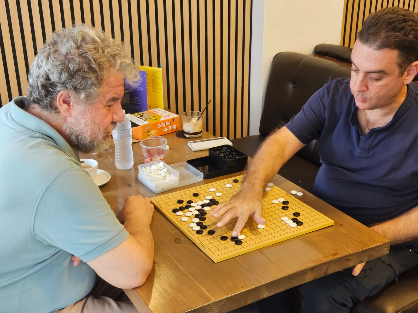 Demetris Regginos (left) playing Go at the cafe